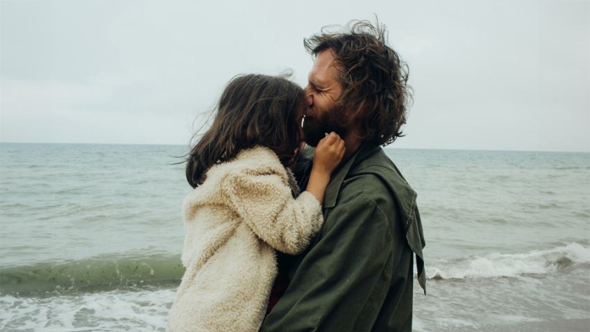 father and daughter hugging on the beach
