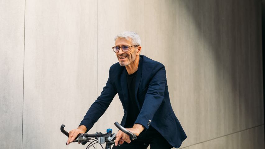 senior man riding bicycle and smiling